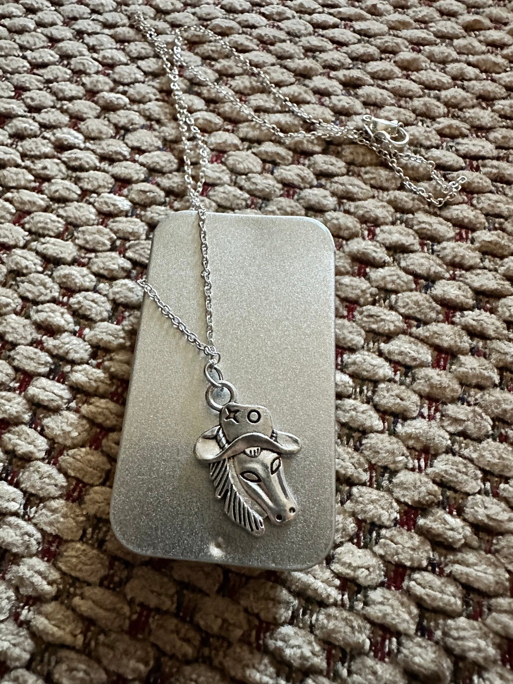 Horse with a hat necklace